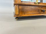 a small wooden dresser with a mirror on top of it