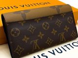 the louis vuitton wallet is sitting on top of a box