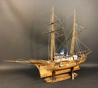 a wooden model of a ship on a stand