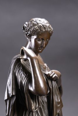 an image of a bronze statue of a woman with her hands on her face