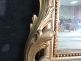 a picture of a gold frame with a mirror in it