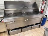 a stainless steel stove with three burners in a kitchen