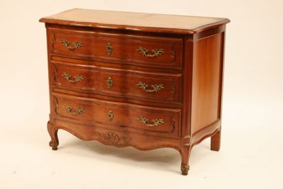 a small wooden chest of drawers on a white background