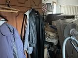 une photo d'une buanderie en désordre avec une machine à laver