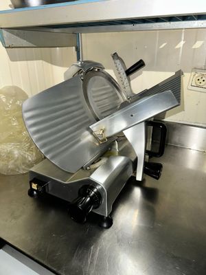 an image of a kitchen counter with a meat slicer on it