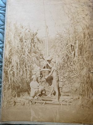 an old photo of a man and a woman in a field
