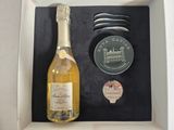 a bottle of wine and a spoon in a box