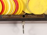 yellow and red discs are arranged on a wooden rack