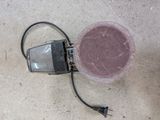 a light that is sitting on the ground next to a cup