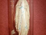 a statue of the virgin mary in a glass clochet