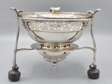 an antique silver plated serving bowl on a stand