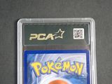 the pokemon card is in the plastic case on the table