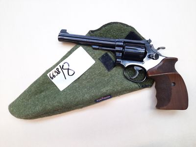 a gun that is laying on top of a green bag