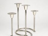 a close up of a metal candle holder on a white background