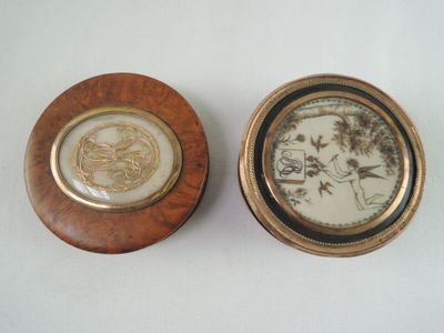 une paire de petites boîtes en bois ornées de motifs décoratifs sur un fond blanc