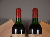 two bottles of wine sitting next to each other on a table