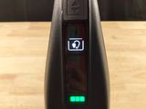 a close up of a remote control on a wooden table
