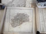 two old maps and a cup of coffee on the table