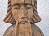 a wooden statue of a man with a beard and a beard