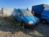 a blue van that is parked next to a blue truck