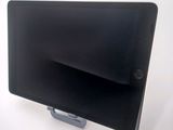 a tablet computer sitting on a stand on a white surface