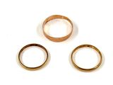 three different types of wedding rings on a white surface