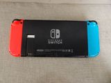 a close up of a nintendo switch lite sitting on top of a couch