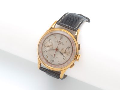 l'image d'une montre en or et noir sur une surface blanche