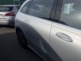 a silver car parked in a parking lot next to other cars
