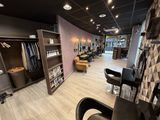 an image of a hair salon with a lot of chairs