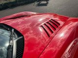 a red sports car parked on the side of the road