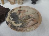 a plate that is sitting on a table next to some vases