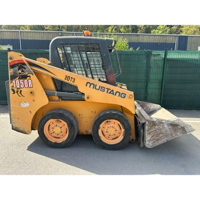 a picture of a yellow ski - loader parked in a parking lot