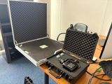une mallette contenant un appareil photo et d'autres équipements, posée sur un bureau