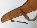 an old leather guitar case with a strap hanging from it ' s side