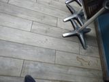 une personne assise sur un banc, les pieds posés par terre