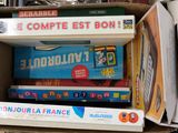 many books in a box on the floor