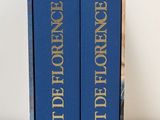 the two books are sitting on a white surface