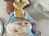 a person holding a plate with a bird on top of it