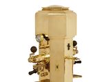 a gold coffee machine that is sitting on a white surface