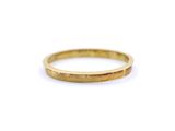 a close up of a gold ring on a white surface