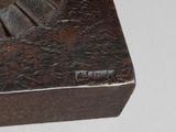 a small wooden box with a metal handle on a table