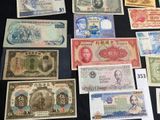 several different types of foreign currency are displayed on a table