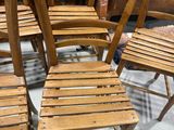 several wooden chairs are lined up in a circle on a floor