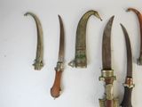 several different types of knives are displayed on a white surface