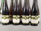 six bottles of wine are lined up in a row on a table