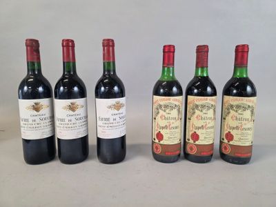 six bottles of red wine are lined up on a table