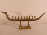 an image of a brass colored menorah with five candles on it