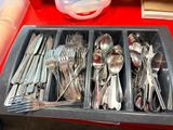 many spoons and spoon spoons in a tray on a table