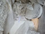 a lot of wedding dresses in a box on the floor